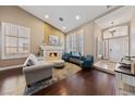 Open-concept living room features a fireplace, plantation shutters, hardwood floors, and an airy atmosphere at 2113 Waterbury Ln, Las Vegas, NV 89134