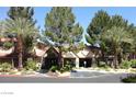 Attractive community entrance, featuring well-maintained landscaping, mature trees, and a welcoming facade at 2200 S Fort Apache Rd # 2062, Las Vegas, NV 89117
