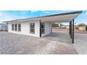 Newly renovated home featuring a covered carport and fresh exterior paint job, with a gravel landscaped yard at 266 Tungsten St, Henderson, NV 89015