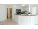Bright kitchen featuring a breakfast bar, white cabinetry, and black appliances at 2753 Devita Cir, Las Vegas, NV 89117