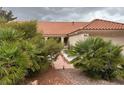 Attractive home featuring a terracotta roof, columned entryway, and well-maintained front yard landscaping at 2801 Golfside Dr, Las Vegas, NV 89134