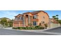 Corner lot home with a three-car garage, lush landscaping, and neutral color scheme at 281 Powerbilt Ave, Las Vegas, NV 89148