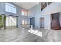 Open-concept living area with staircase, lots of natural light, and stylish tile flooring at 281 Powerbilt Ave, Las Vegas, NV 89148