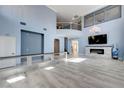 Spacious living room with a fireplace, sleek tiled floors, and access to upper level at 281 Powerbilt Ave, Las Vegas, NV 89148