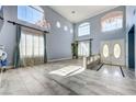 Bright living room with high ceilings, large windows, and elegant chandelier at 281 Powerbilt Ave, Las Vegas, NV 89148