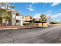 Exterior view of the condo featuring assigned covered parking with well-maintained grounds and landscaping at 3151 Soaring Gulls Dr # 2081, Las Vegas, NV 89128
