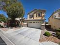 Inviting two-story home featuring a wide driveway and low-maintenance landscaping at 32 Focal Point Ave, North Las Vegas, NV 89031