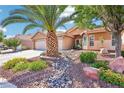 Attractive single-story home with desert landscaping, a palm tree, and a spacious two-car garage at 3913 Ricebird Way, North Las Vegas, NV 89084