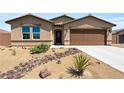 Inviting single-story house featuring desert landscaping, a neutral color palette, and a two-car garage enhances curb appeal at 3966 E Garfield Dr, Pahrump, NV 89061