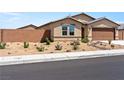 Attractive single-story home with desert landscaping and a brick perimeter wall enhances curb appeal and privacy at 3966 E Garfield Dr, Pahrump, NV 89061