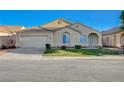 Charming single-story home with a well-maintained lawn, desert landscaping and a two car garage at 4331 Golden Palomino Ln, North Las Vegas, NV 89032