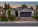 Charming single-story home featuring a two-car garage, brick driveway, and well-manicured landscaping at 4356 E Cactus Canyon Dr, Pahrump, NV 89061
