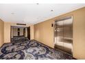 Building hallway with carpeting, painted walls, and access to an elevator at 4381 W Flamingo Rd # 18320, Las Vegas, NV 89103