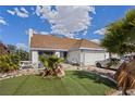 Well-maintained single-story home with a two-car garage and low maintenance desert landscaping in the front yard at 4602 Inland Ct, Las Vegas, NV 89147