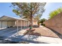 Charming home with covered carport, desert landscaping, and a shade tree at 4735 Roby Grey Way, North Las Vegas, NV 89081
