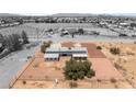 This aerial shot highlights a modern home with solar panels and a large gravel-covered yard at 5085 Raven Ave, Las Vegas, NV 89139