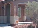 Close-up of the home's front entrance with an archway and desert landscaping at 5852 Clear Haven Ln, North Las Vegas, NV 89081