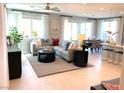 Bright living room featuring neutral tones, large windows with sheer curtains, and a comfortable seating area for relaxation at 6511 Dove Point Pl, Las Vegas, NV 89130
