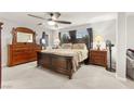 Cozy main bedroom with soft carpet, a ceiling fan, and a large dresser with mirror at 6624 Jade Jaguar St, North Las Vegas, NV 89086