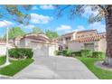 Charming exterior of home features manicured landscaping, driveway, and terracotta roof at 6940 Emerald Springs Ln, Las Vegas, NV 89113