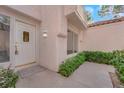 Close up of front door with tiled roof and small garden to side at 6940 Emerald Springs Ln, Las Vegas, NV 89113