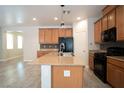 Stylish kitchen with wood-style floors, updated appliances, and oversized island at 7715 Peaceful Trellis Dr, Las Vegas, NV 89179