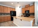 Open kitchen with wooden cabinets, granite countertops, and stylish backsplash at 7715 Peaceful Trellis Dr, Las Vegas, NV 89179