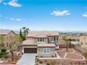 Charming two-story home with stone accents and a well-manicured front yard at 7756 River Mist Ct, Las Vegas, NV 89113