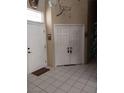 Inviting foyer with double doors, white tile flooring, and a decorative wall design at 7894 W Patrick Ln, Las Vegas, NV 89113