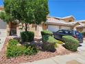 Charming townhome featuring a well-manicured lawn, desert landscaping, and an attached two-car garage at 8072 Cimarron Ridge Dr # 201, Las Vegas, NV 89128