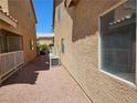 Exterior shot of the side yard with gravel and an air conditioning unit at 8072 Cimarron Ridge Dr # 201, Las Vegas, NV 89128