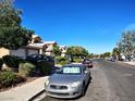 Exterior street view of homes with well-maintained landscaping and parked cars at 8072 Cimarron Ridge Dr # 201, Las Vegas, NV 89128