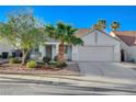 Inviting single-story home with a two-car garage and tidy landscaping at 832 Seco Verde Ave, Henderson, NV 89015