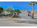 Charming single-story home with a well-maintained lawn and mature palm trees at 832 Seco Verde Ave, Henderson, NV 89015