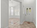 Bright foyer featuring neutral paint, tiled flooring with decorative borders, and natural light at 8337 Willow Basin Ct, Las Vegas, NV 89131