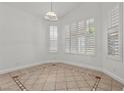 Inviting living room featuring tile flooring, neutral paint, shuttered windows, and ample natural light at 8337 Willow Basin Ct, Las Vegas, NV 89131