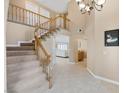 Welcoming foyer featuring staircase with wooden railing and neutral color palette at 9404 Low Tide Ct, Las Vegas, NV 89117