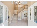Bright foyer with staircase, tile flooring, and soaring ceilings at 9404 Low Tide Ct, Las Vegas, NV 89117