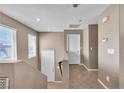 Upstairs hallway with neutral tones, tile floors, and doors leading to various rooms at 9541 Vast Valley Ave, Las Vegas, NV 89148