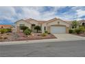 Inviting one-story home featuring a two-car garage and drought-tolerant landscaping at 10513 Longwood Dr, Las Vegas, NV 89134