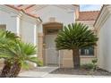 Close up of front entryway with front door, security gate and desert landscaping at 10513 Longwood Dr, Las Vegas, NV 89134
