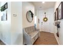 Inviting entryway with wood-look tile flooring, a wooden bench, and bright white walls at 10750 Red Badge Ave, Las Vegas, NV 89166