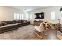 Comfortable living room with a sectional sofa, neutral tones, and shuttered windows at 10750 Red Badge Ave, Las Vegas, NV 89166