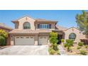 Inviting two-story home featuring a tile roof, a two-car garage, and desert landscaping at 11112 Pine Greens Ct, Las Vegas, NV 89144