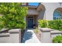 Inviting entryway featuring a double front door and manicured landscaping at 11112 Pine Greens Ct, Las Vegas, NV 89144