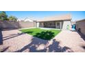 A spacious backyard featuring gravel and artificial turf, perfect for outdoor activities and enjoyment at 11119 River Hills Ln, Las Vegas, NV 89135