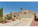 View of a single-story home featuring desert landscaping, tile roof, and attached two-car garage at 1536 Leatherleaf Dr, Las Vegas, NV 89123