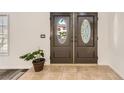 Elegant double front doors with decorative glass inserts and neutral tile flooring at 1538 Pony Ranch Cir, Henderson, NV 89014