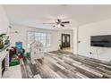 Cozy living room with neutral walls, wood-look flooring, and a view of the front entrance at 1538 Pony Ranch Cir, Henderson, NV 89014
