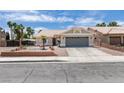 Charming single-story home with a well-maintained yard, two car garage, and neutral color palette at 1673 Golden Vista Dr, Las Vegas, NV 89123
